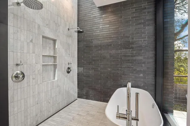 a bathroom with a tub and shower