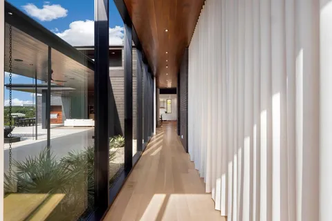 a view of a hallway with wooden floor and stairs