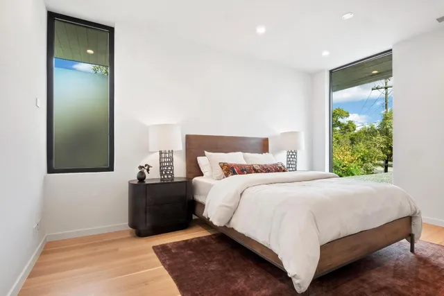 a bedroom with a bed and a mirror