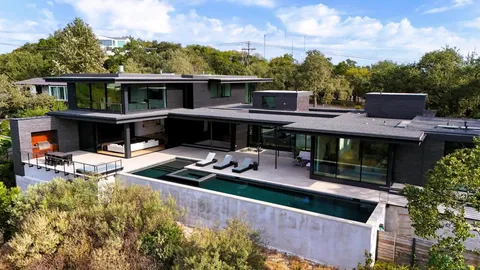 a view of house with outdoor space swimming pool and furniture