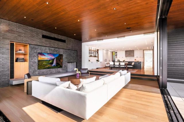 a living room with fireplace furniture and a flat screen tv