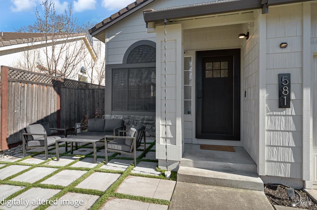 a view of backyard with a chair and glass door