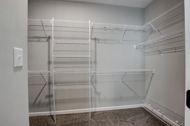 a view of walk in closet with empty racks