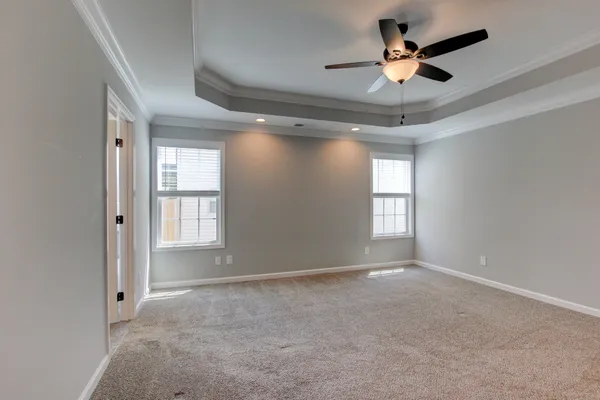 a view of an empty room and a ceiling fan