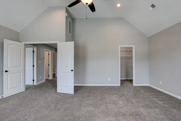 a view of a room with a window and a ceiling fan