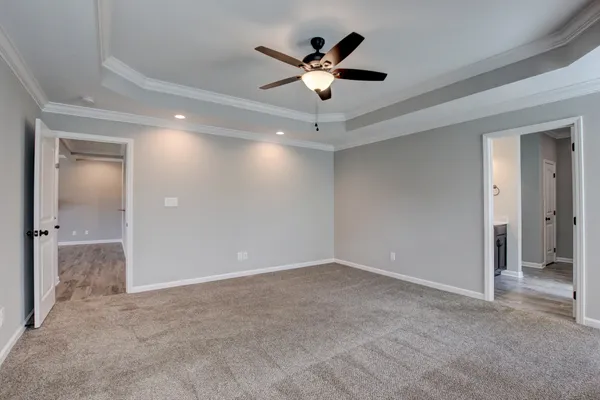 wooden floor in an empty room and a ceiling fan