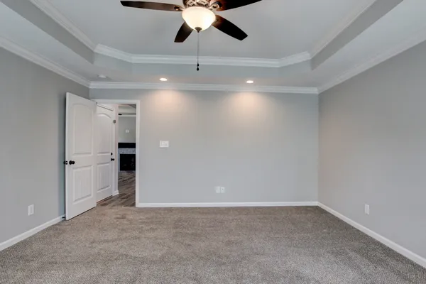 en empty room with a ceiling fan and a window