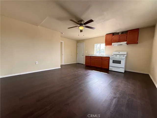 a room with wooden floor and windows