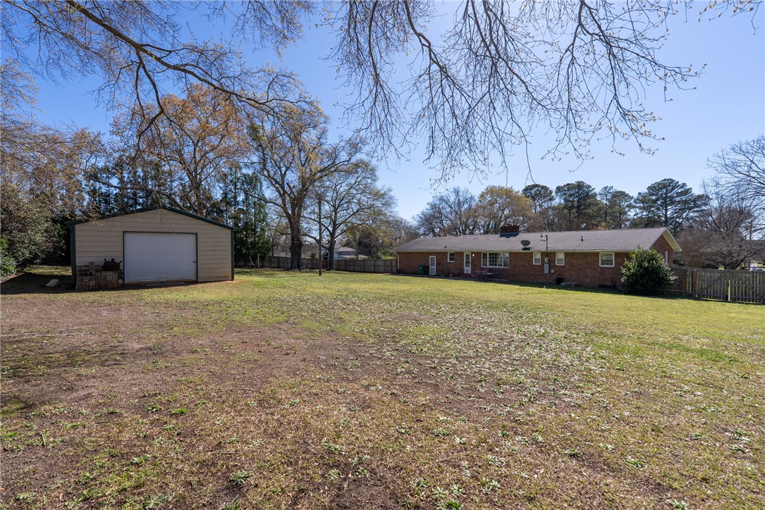 300 Green Street Williamston, SC 29697 - Photo 25 of 47 This spacious backyard includes a brick home and a separate storage building with a roll-up door.