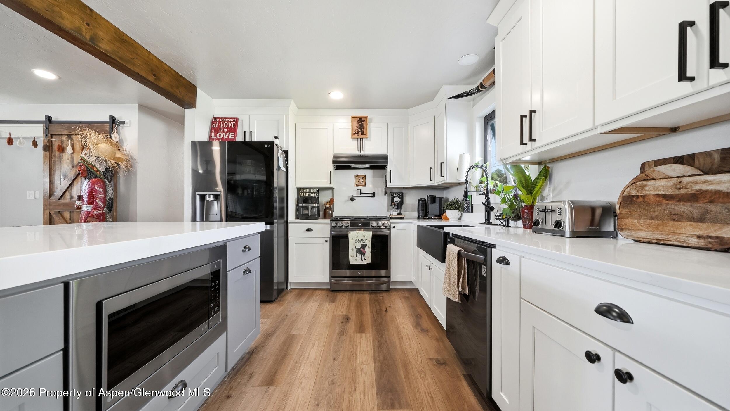 445 South Camp Road Grand Junction, CO 81507 - Photo 13 of 37 a kitchen with stainless steel appliances kitchen island wooden cabinets and granite counter tops