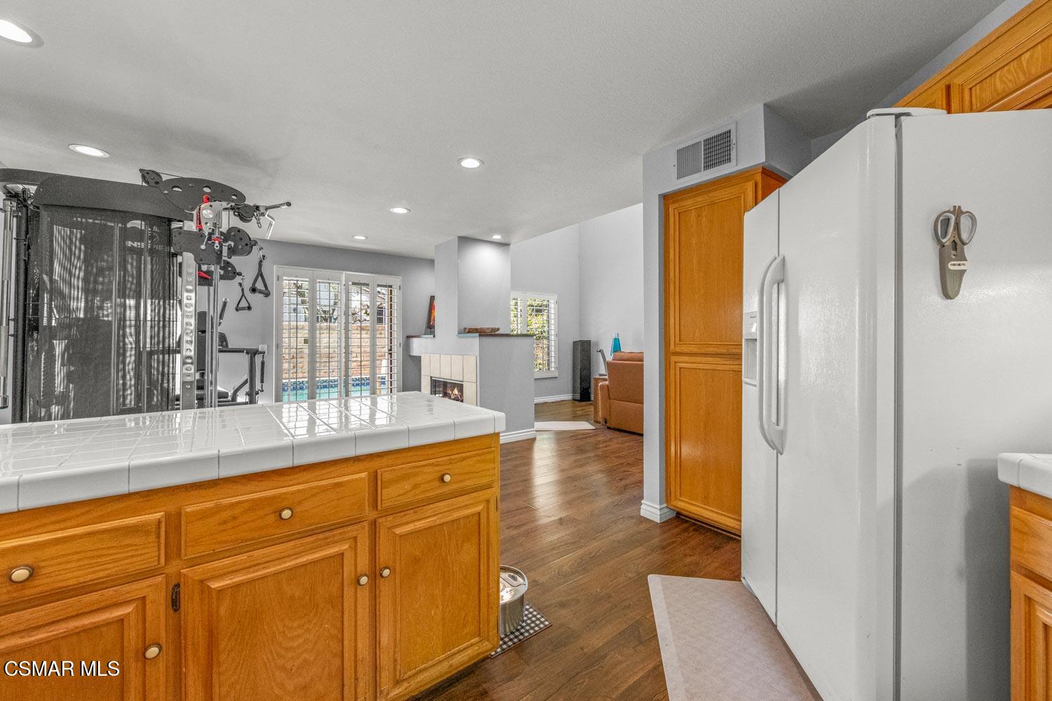 1741 Chaps Court Simi Valley, CA 93063 - Photo 11 of 28 a hallway with cabinets a sink a dining table and chairs