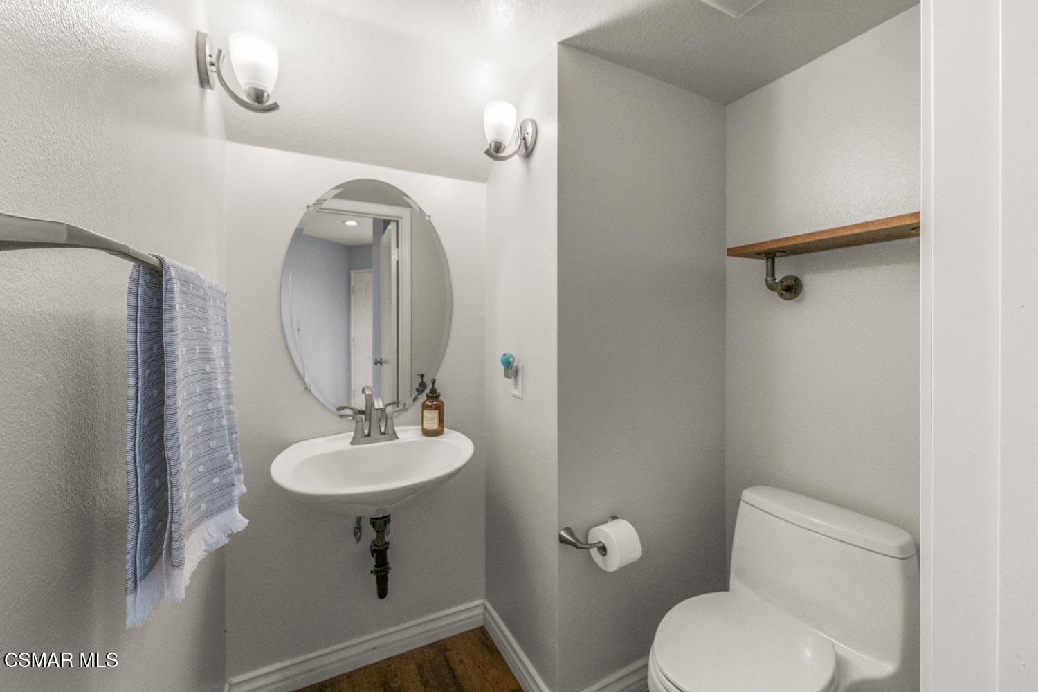 1741 Chaps Court Simi Valley, CA 93063 - Photo 6 of 28 a bathroom with a toilet a sink and mirror