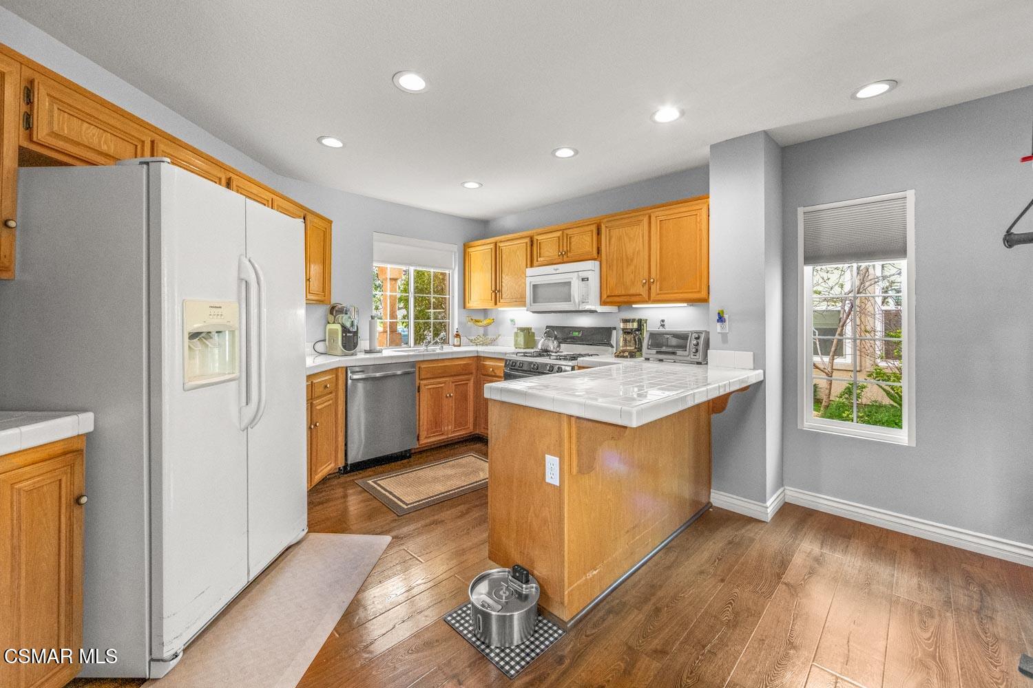 1741 Chaps Court Simi Valley, CA 93063 - Photo 9 of 28 a kitchen with a sink appliances cabinets and a counter top space