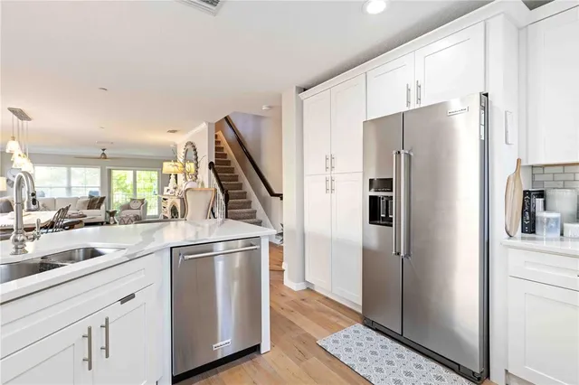 a kitchen with a refrigerator and a sink
