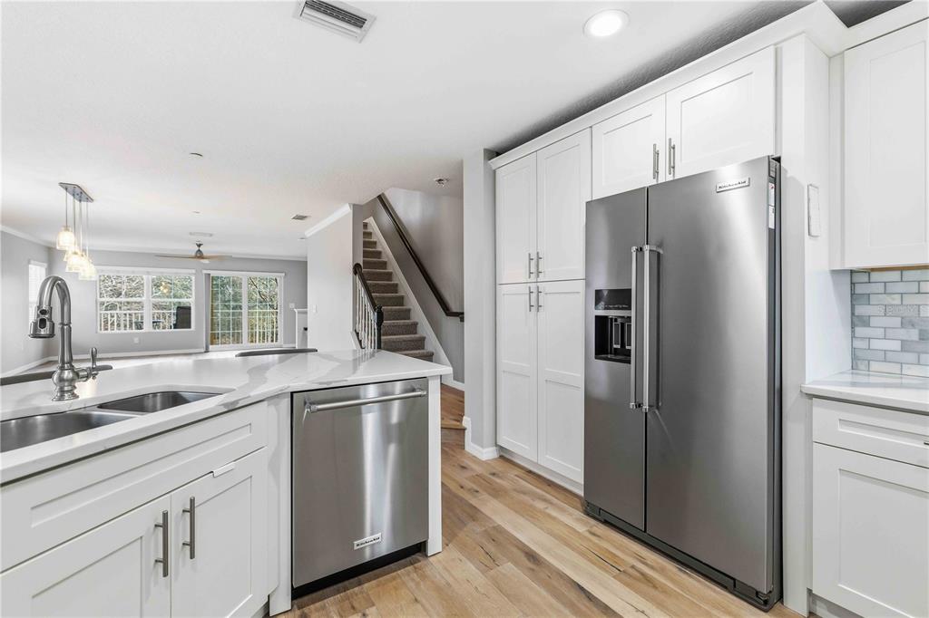 9040 White Sage Loop Lakewood Ranch, FL 34202 - Photo 14 of 59 a kitchen with stainless steel appliances a refrigerator and a sink