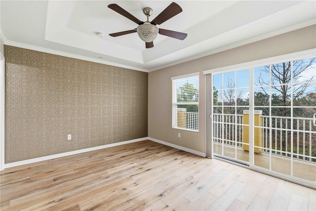 9040 White Sage Loop Lakewood Ranch, FL 34202 - Photo 18 of 59 an empty room with wooden floor and windows