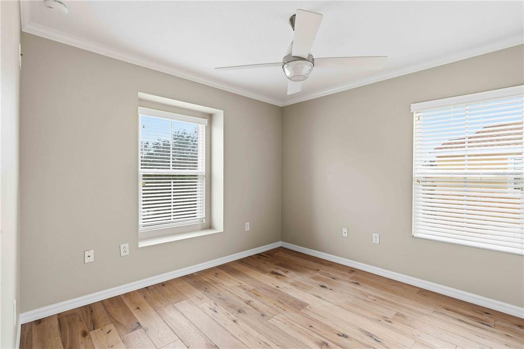 9040 White Sage Loop Lakewood Ranch, FL 34202 - Photo 25 of 59 a view of empty room with wooden floor and fan