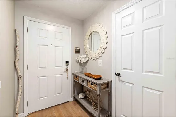 a view of an entryway with wooden floor