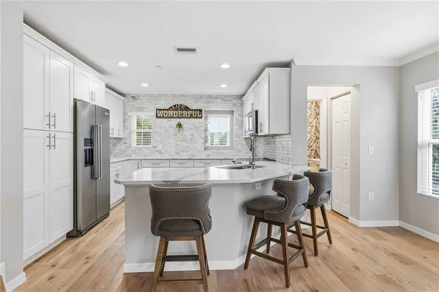 a kitchen with stainless steel appliances granite countertop a stove top oven microwave and cabinets