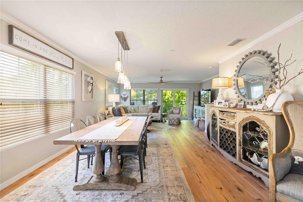 9040 White Sage Loop Lakewood Ranch, FL 34202 - Photo 35 of 59 a view of a dining room with furniture window and wooden floor