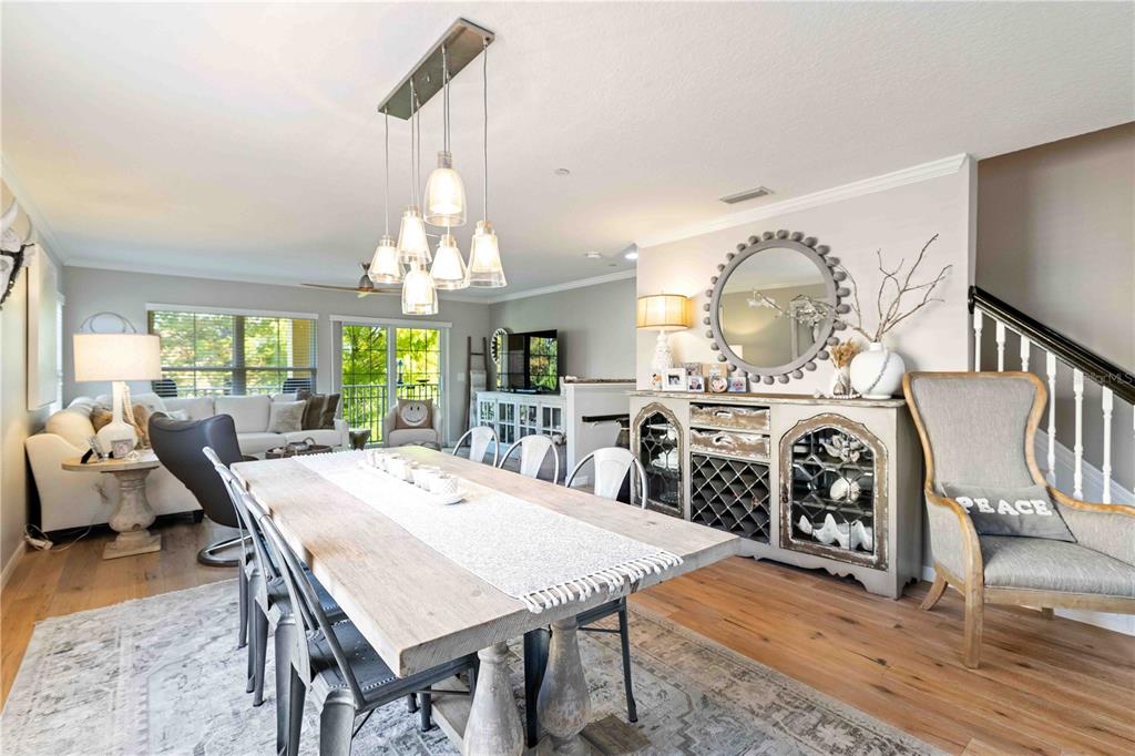 9040 White Sage Loop Lakewood Ranch, FL 34202 - Photo 44 of 59 a view of a dining room with furniture a chandelier and wooden floor