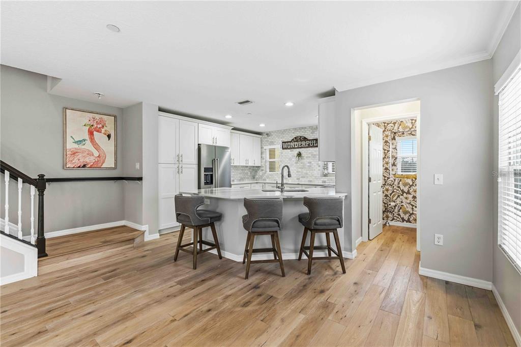 9040 White Sage Loop Lakewood Ranch, FL 34202 - Photo 8 of 59 a view of a dining room with furniture and wooden floor