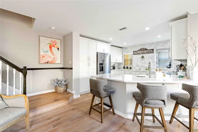 a large kitchen with a table and chairs