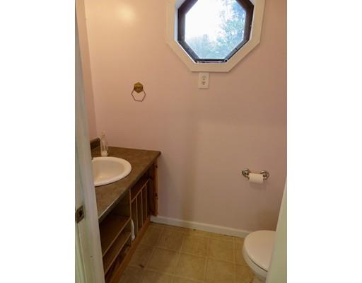 208 Reservoir Road Westhampton, MA 01027 - Photo 17 of 30 a bathroom with a sink a toilet and a mirror