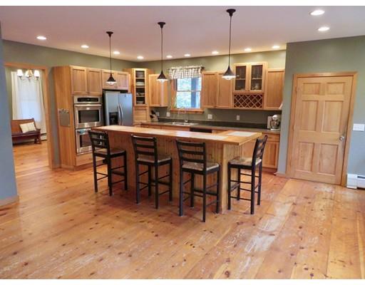 208 Reservoir Road Westhampton, MA 01027 - Photo 7 of 30 a kitchen with stainless steel appliances kitchen island granite countertop a table chairs sink and cabinets