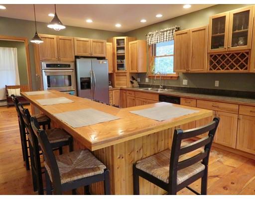 208 Reservoir Road Westhampton, MA 01027 - Photo 8 of 30 a kitchen with a table chairs microwave and refrigerator