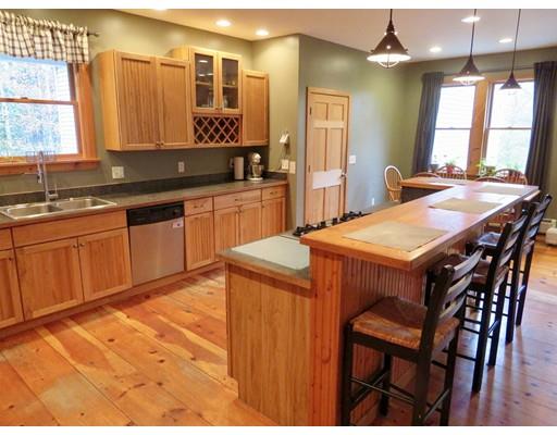 208 Reservoir Road Westhampton, MA 01027 - Photo 9 of 30 a kitchen with stainless steel appliances granite countertop a table chairs sink and window