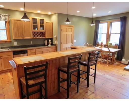 208 Reservoir Road Westhampton, MA 01027 - Photo 10 of 30 a kitchen with a table chairs sink and wooden floor