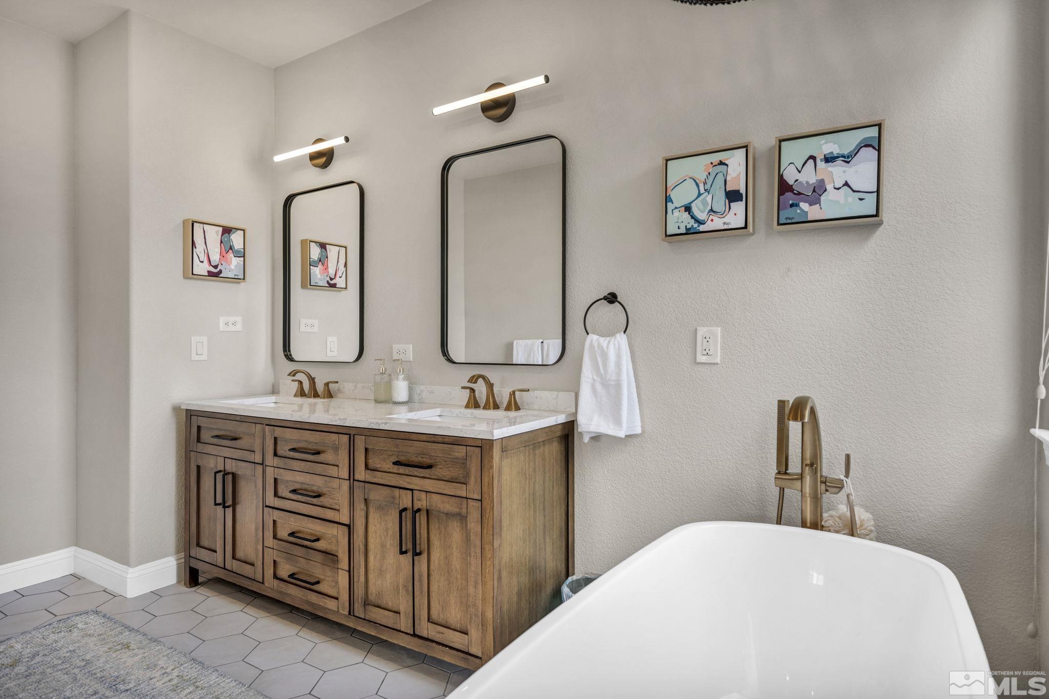 665 Paso Fino Court Reno, NV 89521 - Photo 29 of 40 a bathroom with a double vanity sink and a mirror