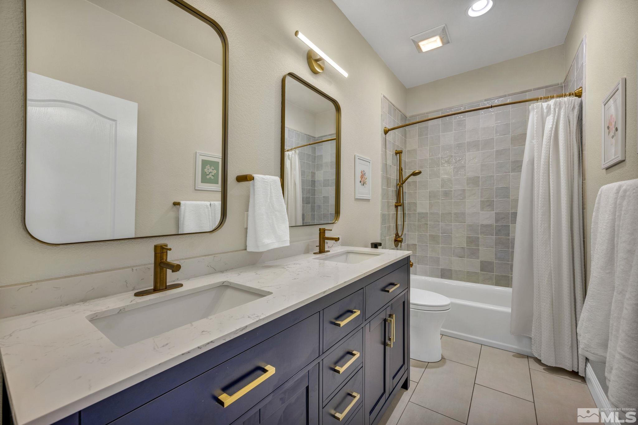 665 Paso Fino Court Reno, NV 89521 - Photo 32 of 40 a bathroom with a sink double vanity and a mirror
