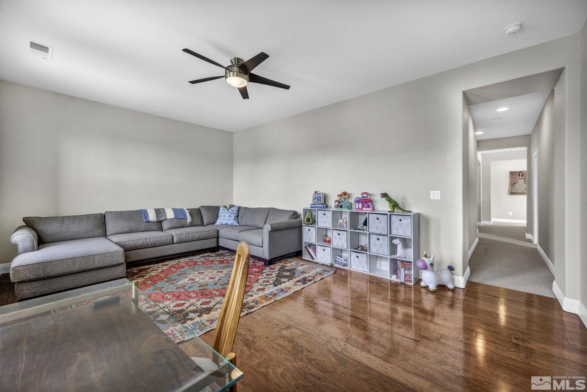 665 Paso Fino Court Reno, NV 89521 - Photo 34 of 40 a living room with furniture and a wooden floor