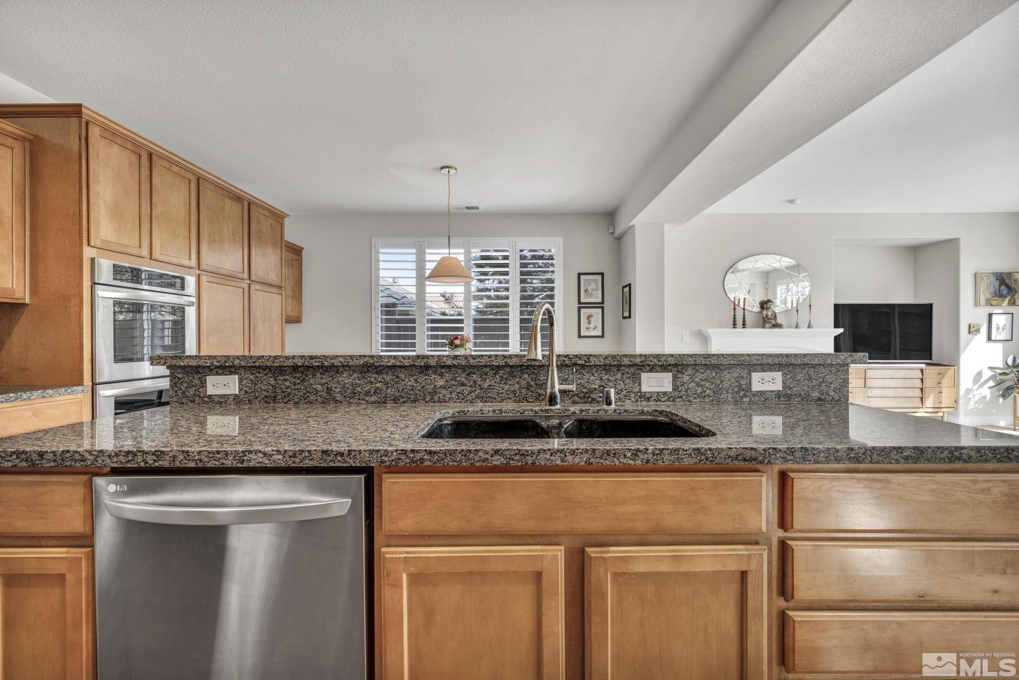 665 Paso Fino Court Reno, NV 89521 - Photo 8 of 40 a kitchen with granite countertop a sink and cabinets