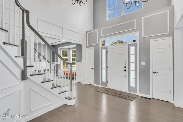 a view of entryway livingroom and hall with wooden floor