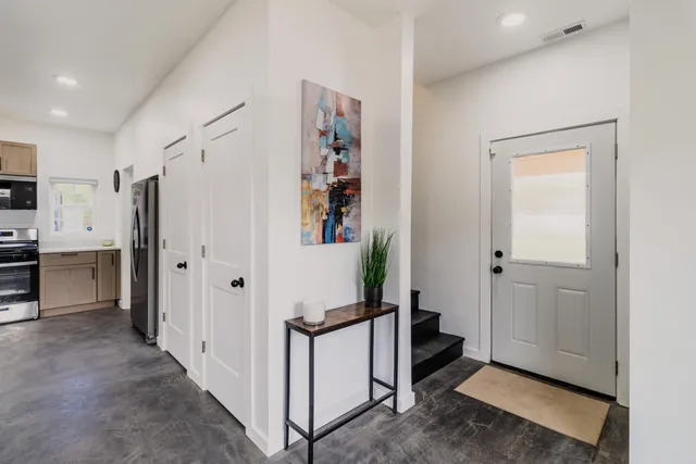 a view of a hallway with wooden floor