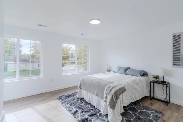 a bedroom with a bed and a window