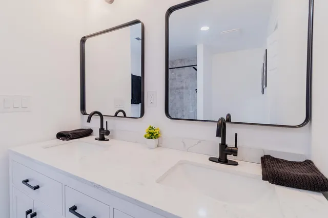 a bathroom with a tub sink toilet and a mirror