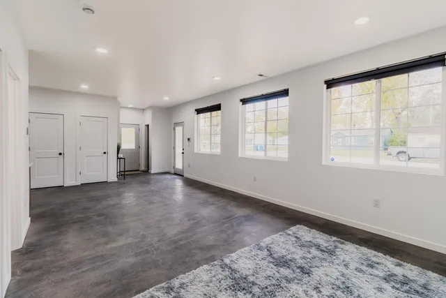 a kitchen with stainless steel appliances granite countertop a refrigerator and a stove top oven
