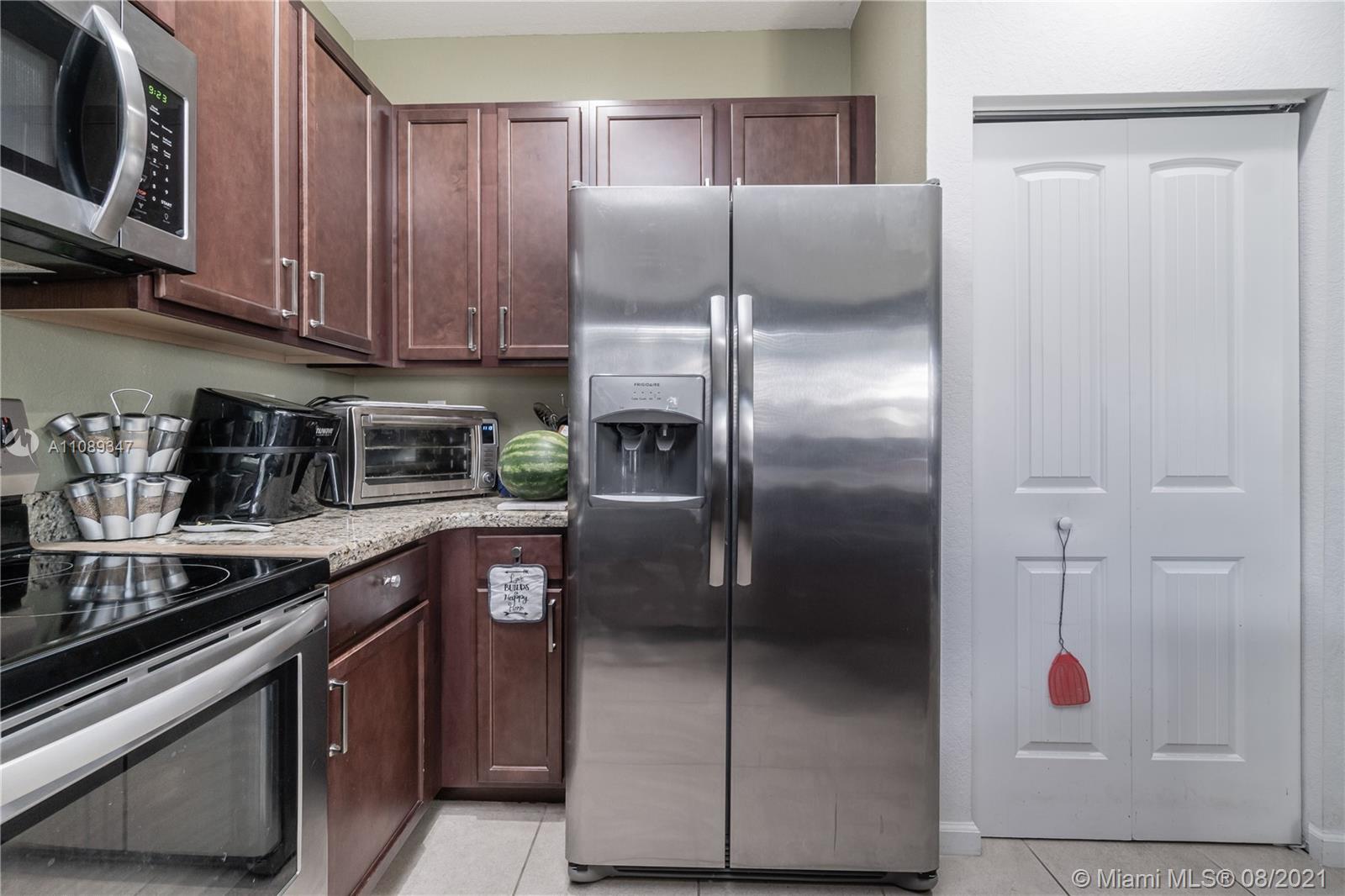 12119 Southwest 253rd Street Homestead, FL 33032 - Photo 16 of 46 a kitchen with stainless steel appliances granite countertop a refrigerator and a sink