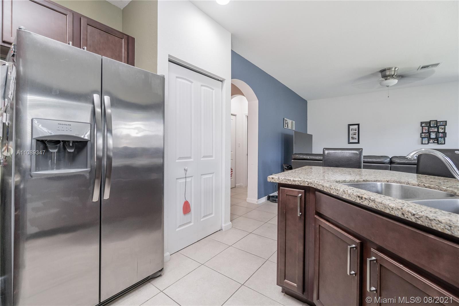 12119 Southwest 253rd Street Homestead, FL 33032 - Photo 17 of 46 a kitchen with stainless steel appliances granite countertop a refrigerator and a sink