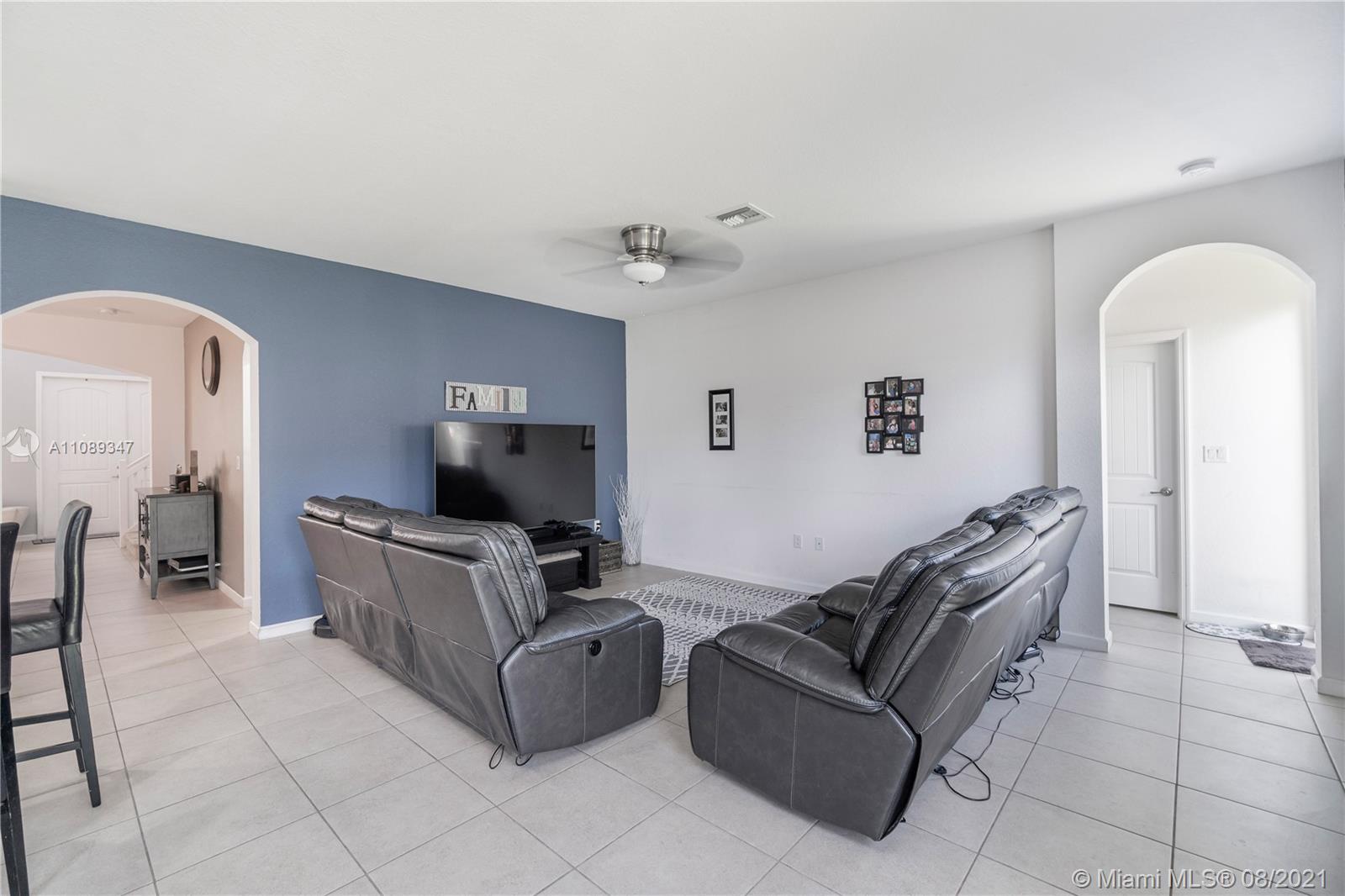12119 Southwest 253rd Street Homestead, FL 33032 - Photo 19 of 46 a living room with furniture and a chandelier