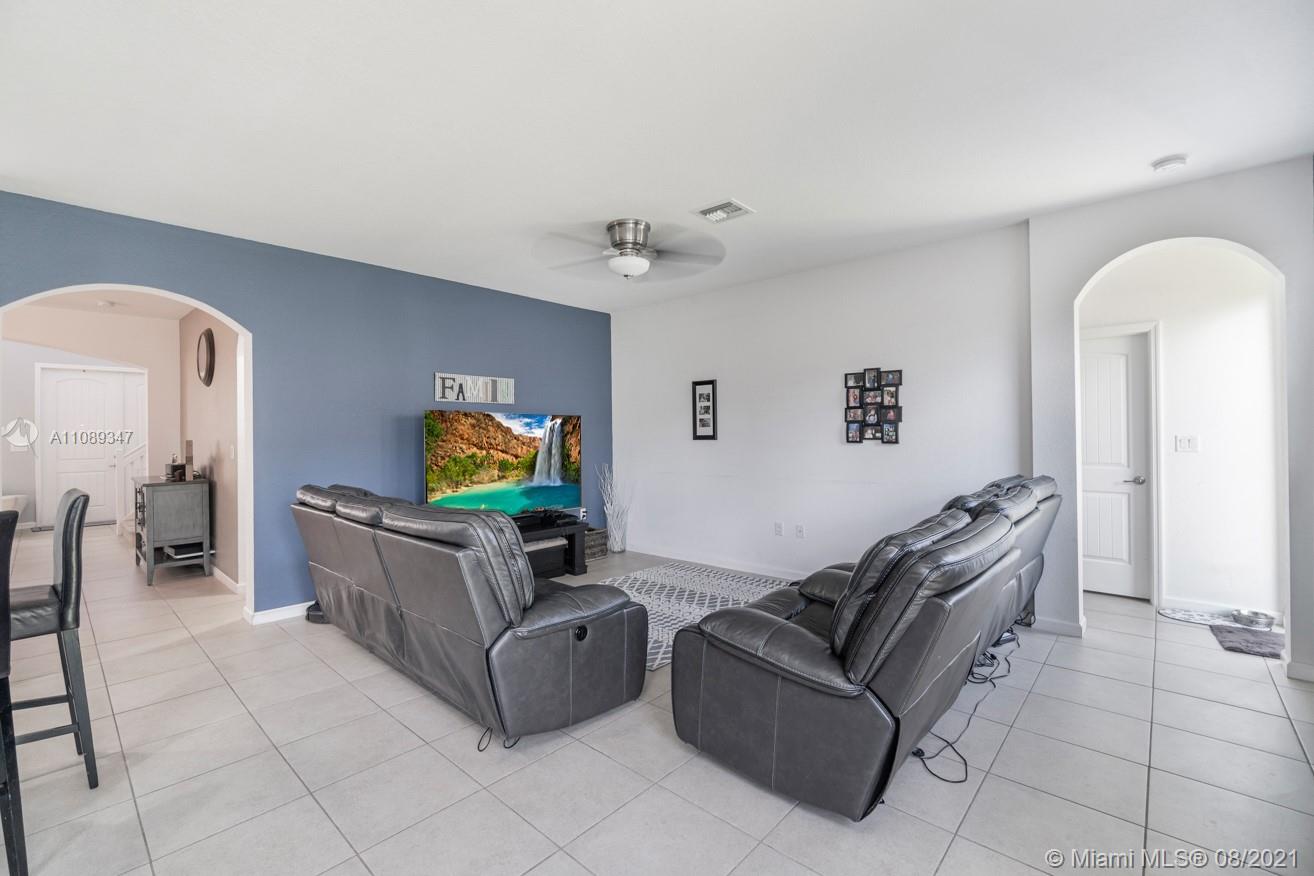 12119 Southwest 253rd Street Homestead, FL 33032 - Photo 23 of 46 a living room with furniture and a flat screen tv