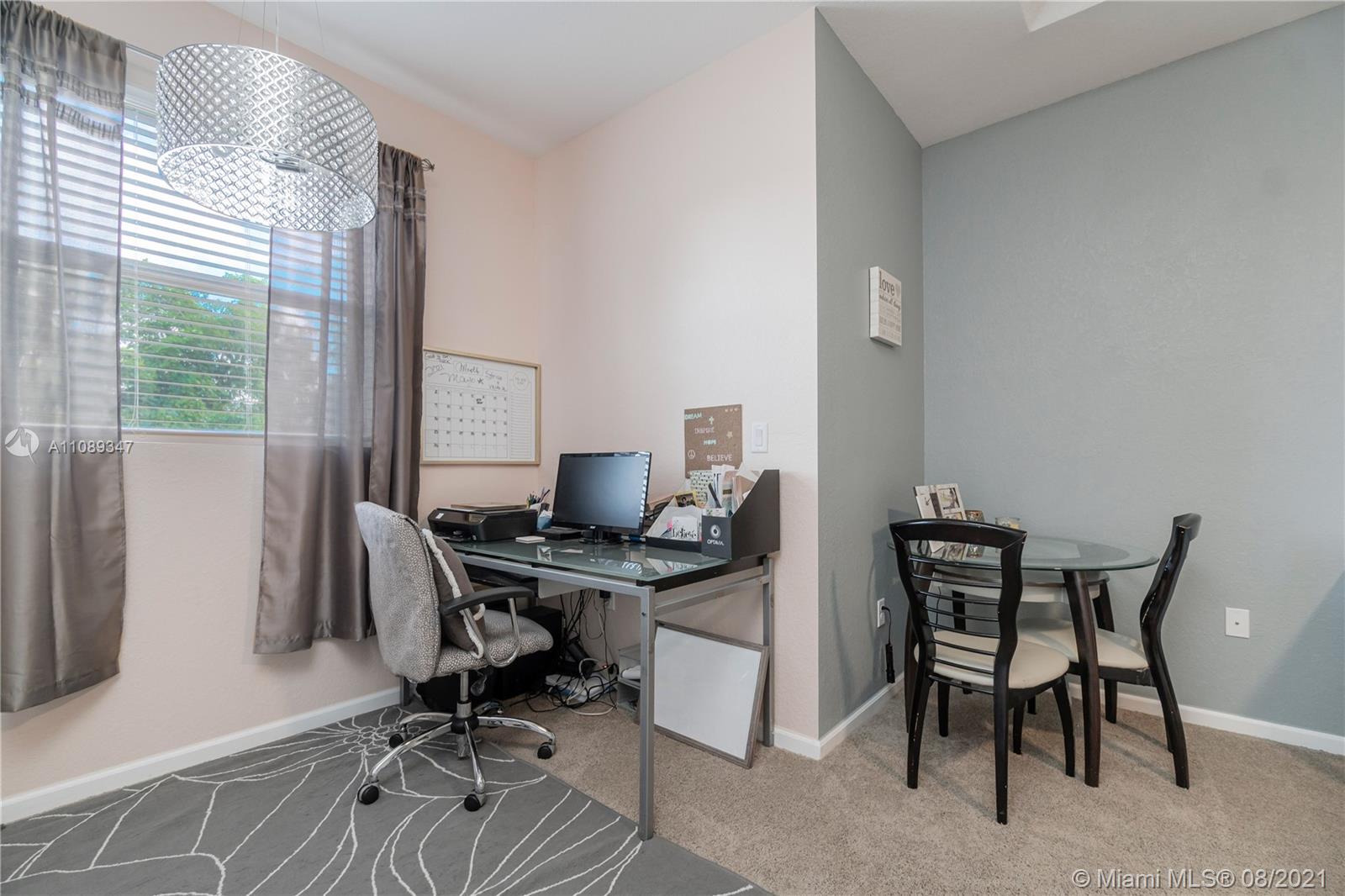 12119 Southwest 253rd Street Homestead, FL 33032 - Photo 25 of 46 a view of a workspace with furniture and a window