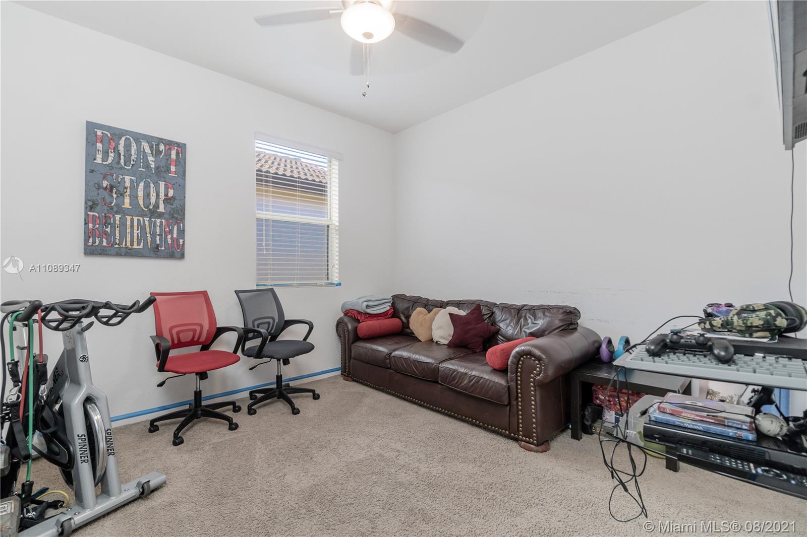 12119 Southwest 253rd Street Homestead, FL 33032 - Photo 27 of 46 a living room with furniture and a gym machine