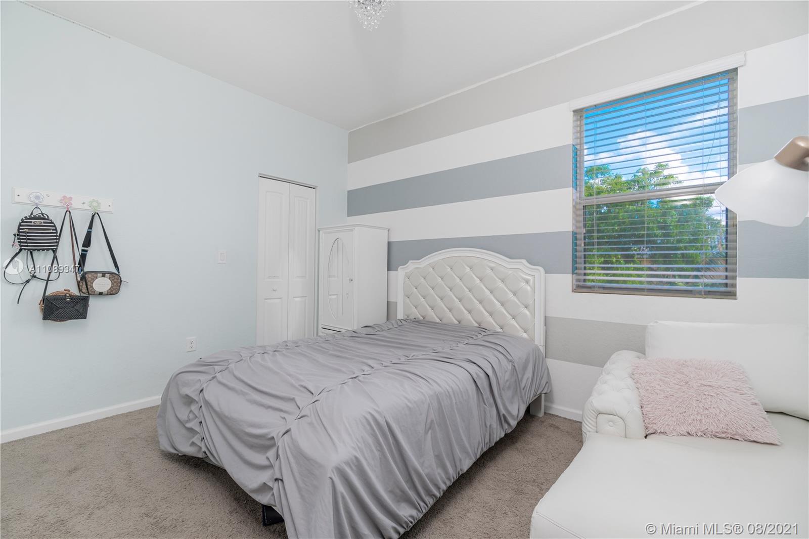 12119 Southwest 253rd Street Homestead, FL 33032 - Photo 28 of 46 a bedroom with bed and window