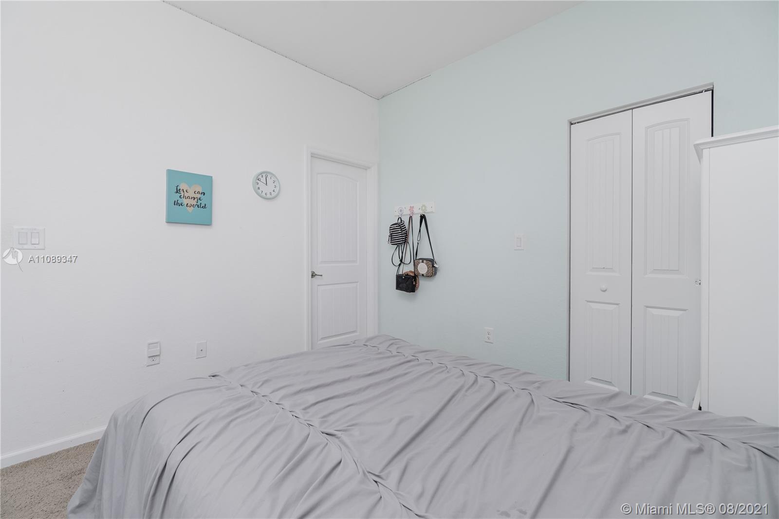 12119 Southwest 253rd Street Homestead, FL 33032 - Photo 29 of 46 a bedroom with a bed and a window