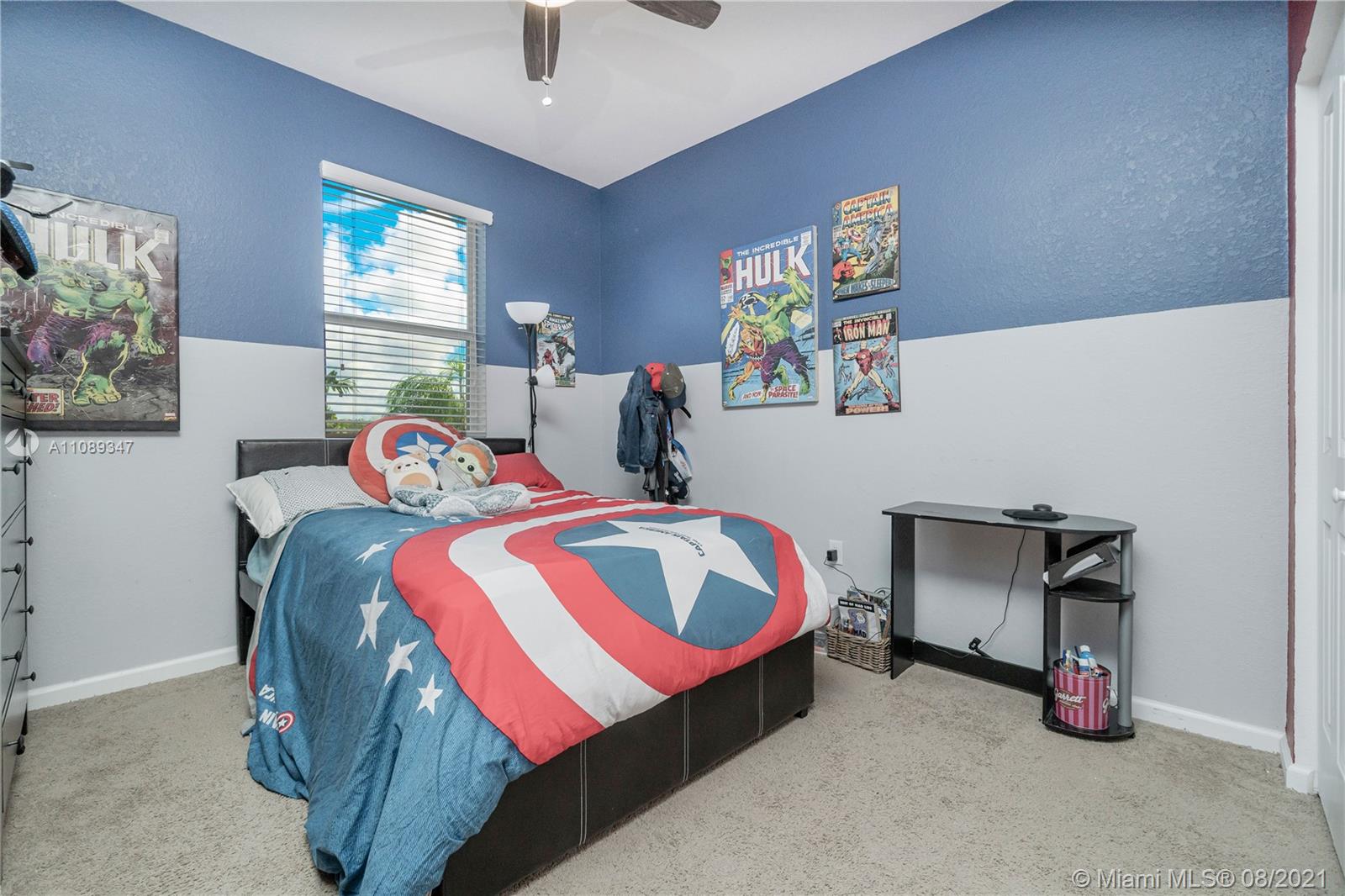12119 Southwest 253rd Street Homestead, FL 33032 - Photo 30 of 46 a bedroom with a bed and a chandelier